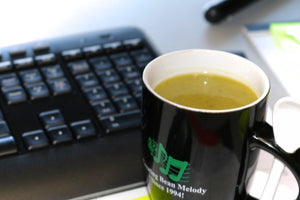 Green Pea Soup in a cup on a desk